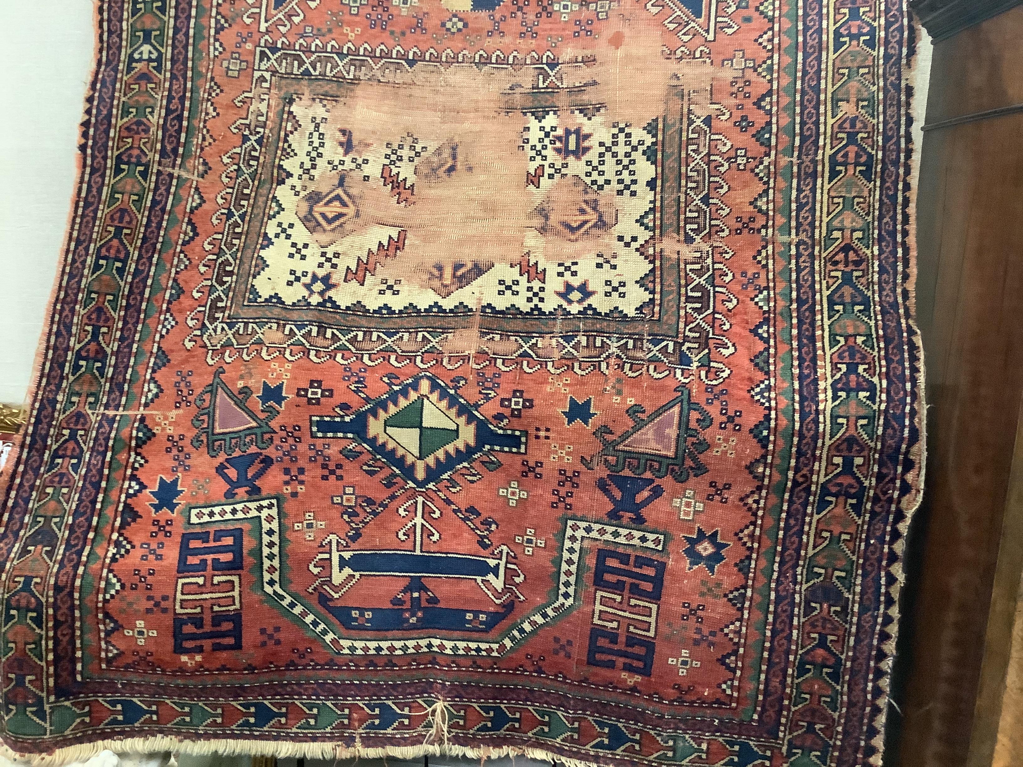 An antique Kazak red ground prayer rug180cm x 135cm.